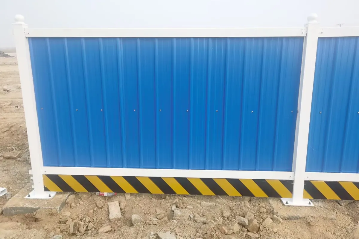 Powder coated temporary fence panel set up as road works traffic barrier on motorway shoulder lane