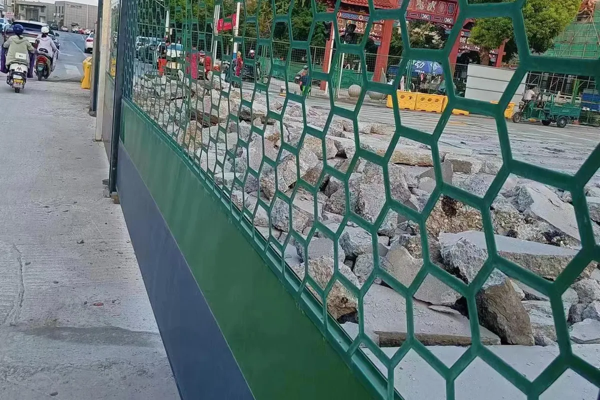 See-through municipal project barrier integrated with urban streetscape