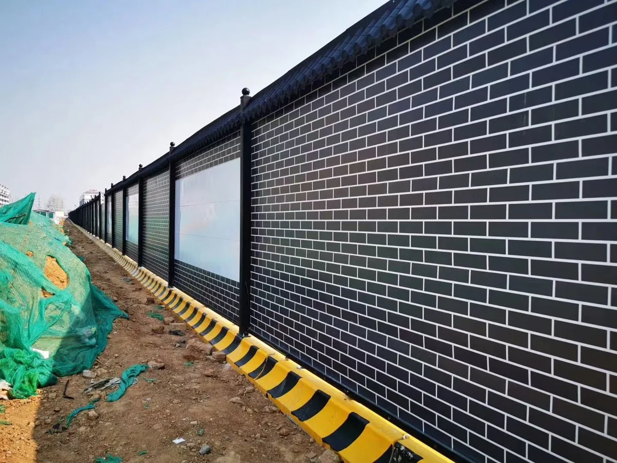 Row of galvanized welded mesh temporary construction fence panels lined up at site perimeter