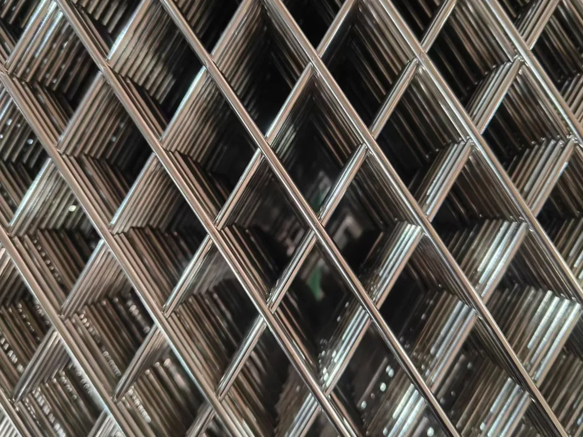 Stainless steel wire mesh panel weld intersection close-up showing precision welding