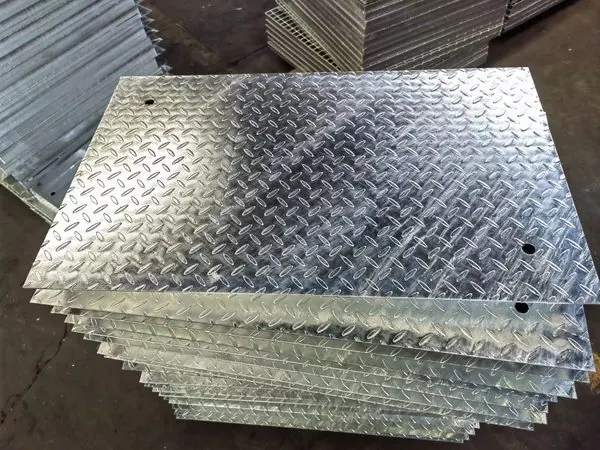 Composite steel grating with checker plate top for dropped object protection