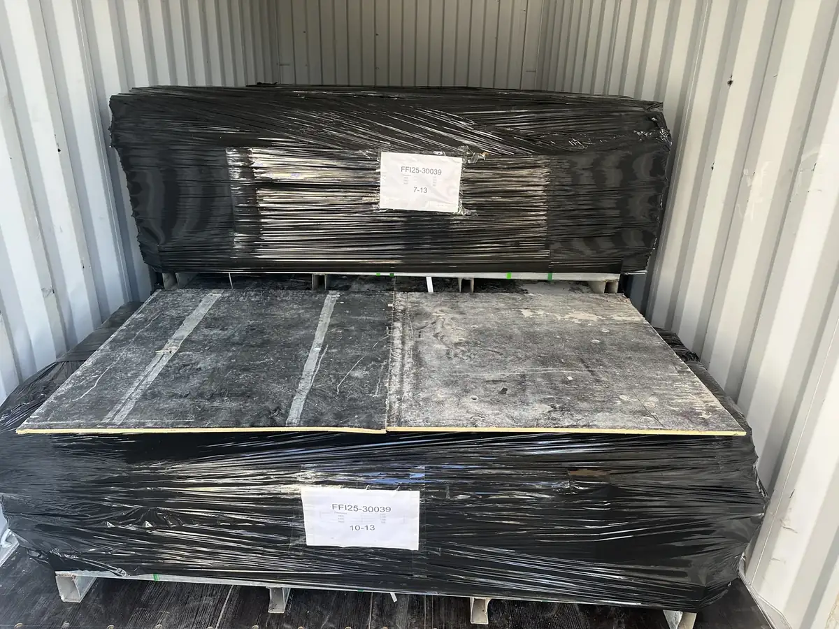 Anping Hand in Hand workshop — palletized products wrapped in black film inside container, container-ready packing for overseas shipment (contract manufacturing for Anping trading partner)