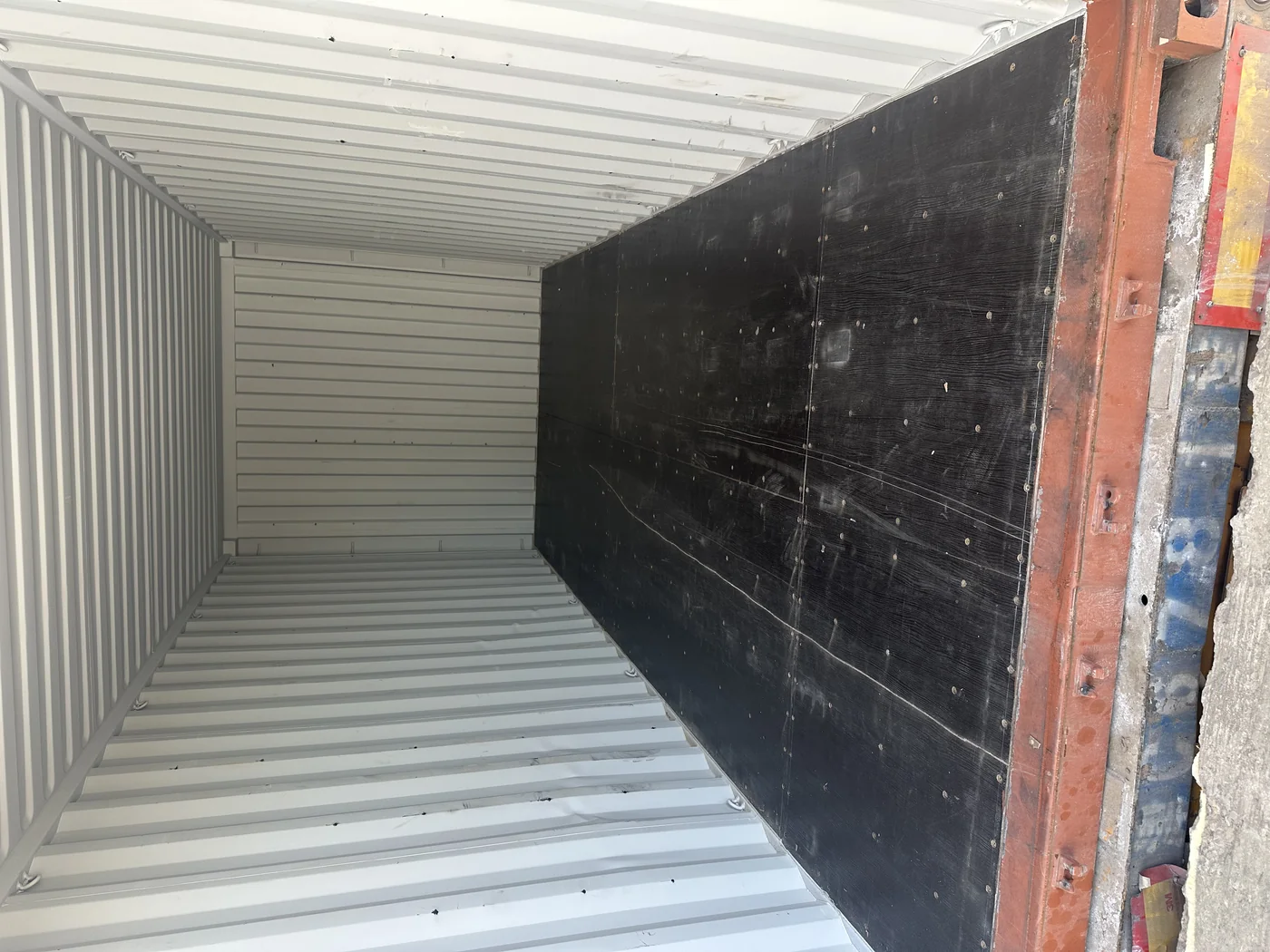 Anping Hand in Hand workshop — inside container during loading, palletized products against corrugated wall